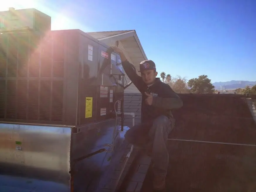 HVAC technician performing HVAC Inspection on a rooftop unit in Oak View